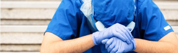 Nurse with head in their hands