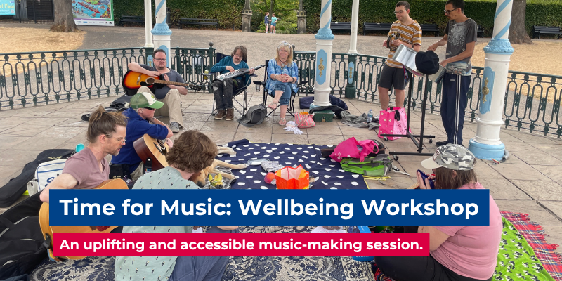 Nine people playing guitars and percussion instruments in an outdoor bandstand. There are two digitally added banners advertising “Time for Music: Wellbeing Workshop,” "an uplifting and accessible music-making session".