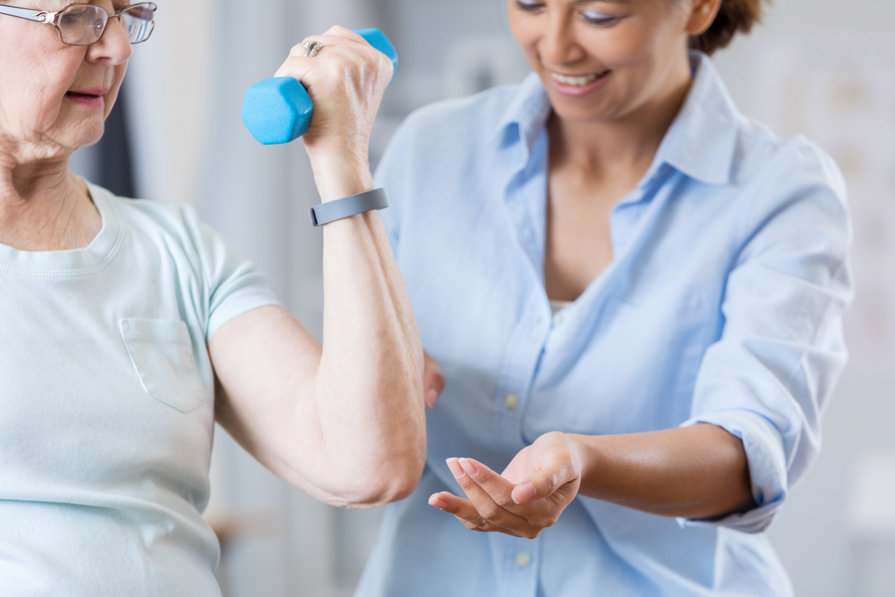 elderly lady exercising with nurse