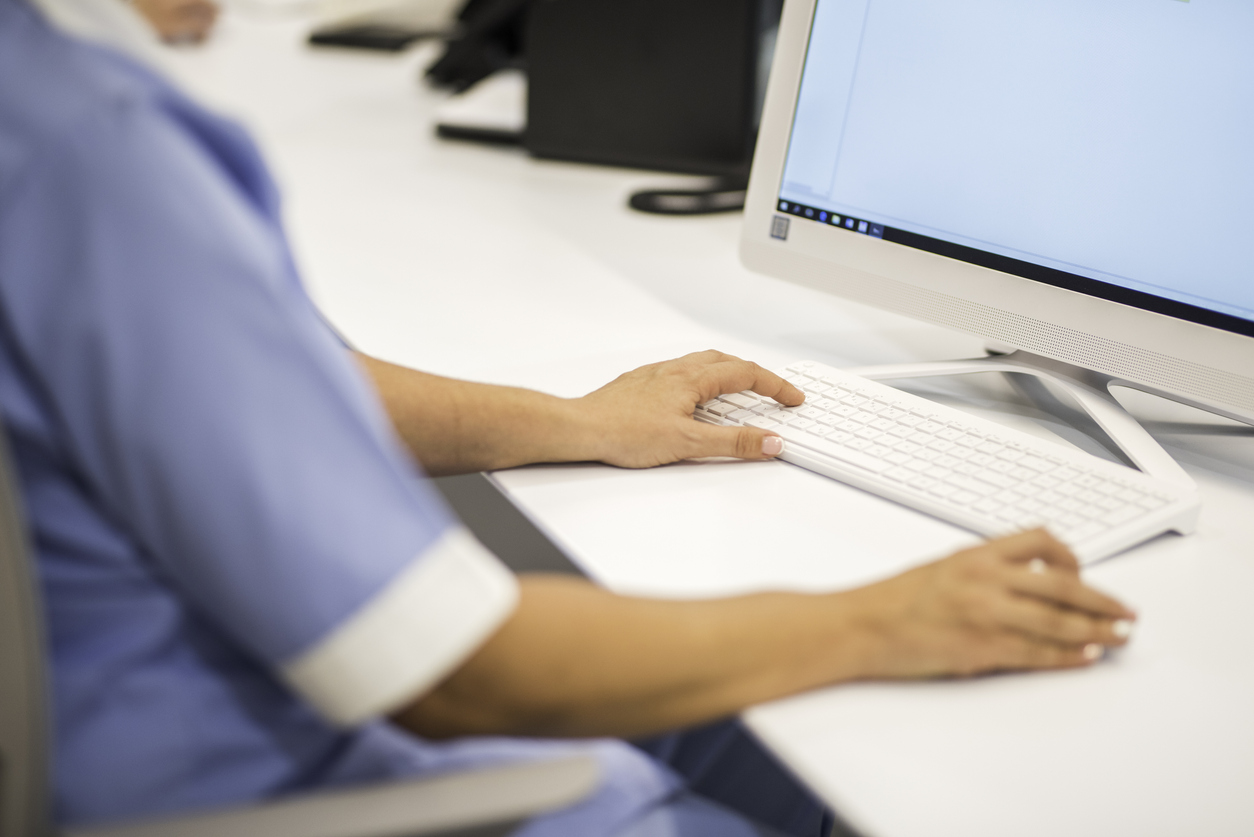 nurse manager typing on computer