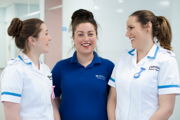 three smiling female student nurses