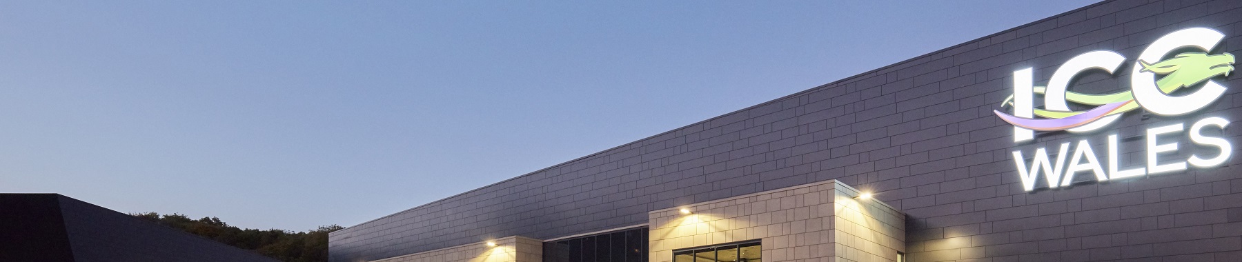 The outside of a building with an illuminated sign reading 'ICC Wales'