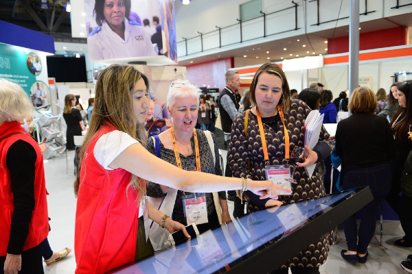 Congress attendees looking at a digital screen