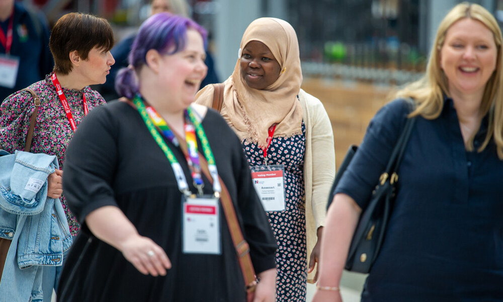 Four female Congress attendees laughing together