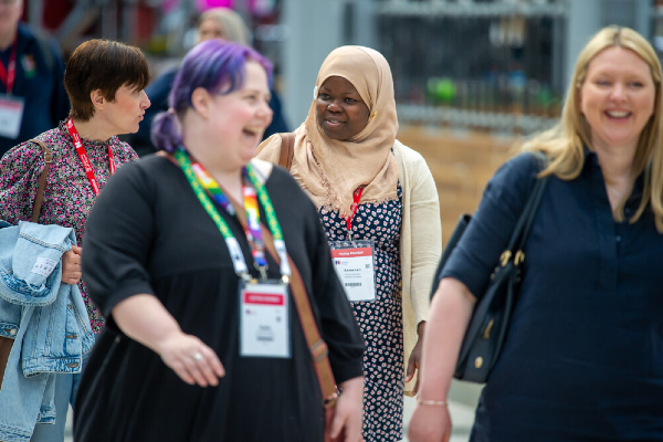 Four female Congress attendees laughing together