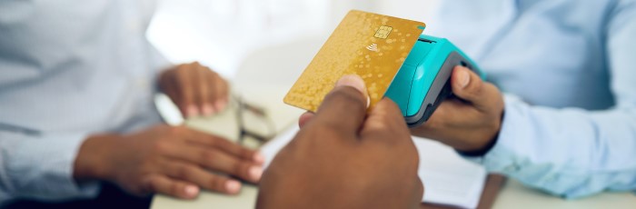 People tapping debit card on contactless machine