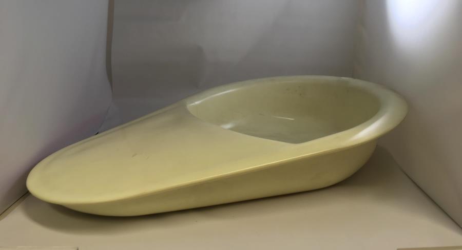 Plastic slipper bed pan, c.1960. At this time, bedrest was still considered an important part of recovery. This meant the continued use of bed pans, particularly in patients’ own homes when supported by a district nurse. Loaned from the British Red Cross Museum and Archive.