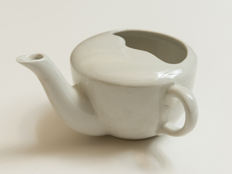 white porcelain feeding cup (cup with a handle and a spout)