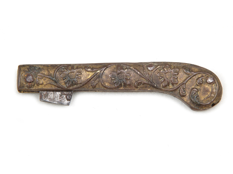 photo of a historical pen knife, the object is brown and has floral decorative features