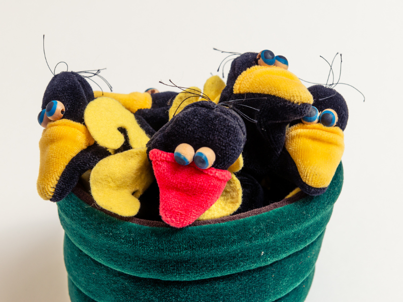 photo of fabric toy bird puppets in a nest
