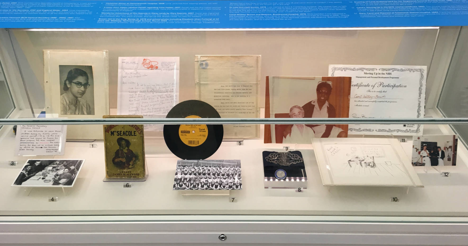 A display case showing items of personal stories of BAME nurses
