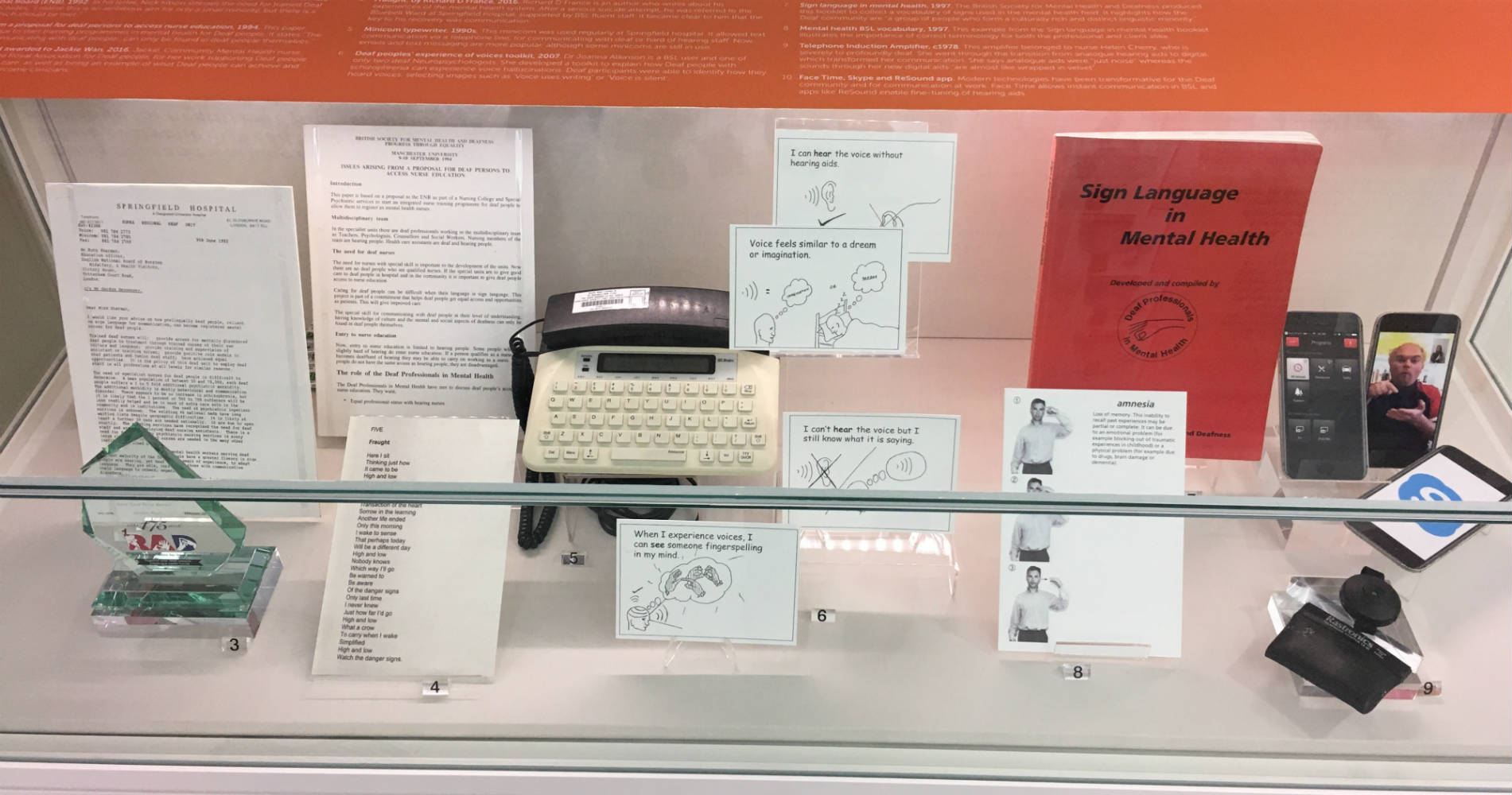 A display case showing items of the D/deaf nursing experience