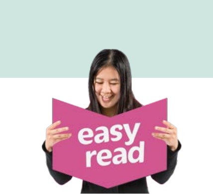 A person holding a pink sign which says: 'Easy Read'