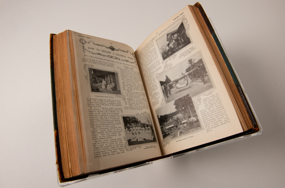 An opened book resting on a stand, the double-page spread visible is titled 'HOW TO BECOME A COLONIAL NURSE'. It includes several paragraphs of text as well as five greyscale images about colonial nursing life.