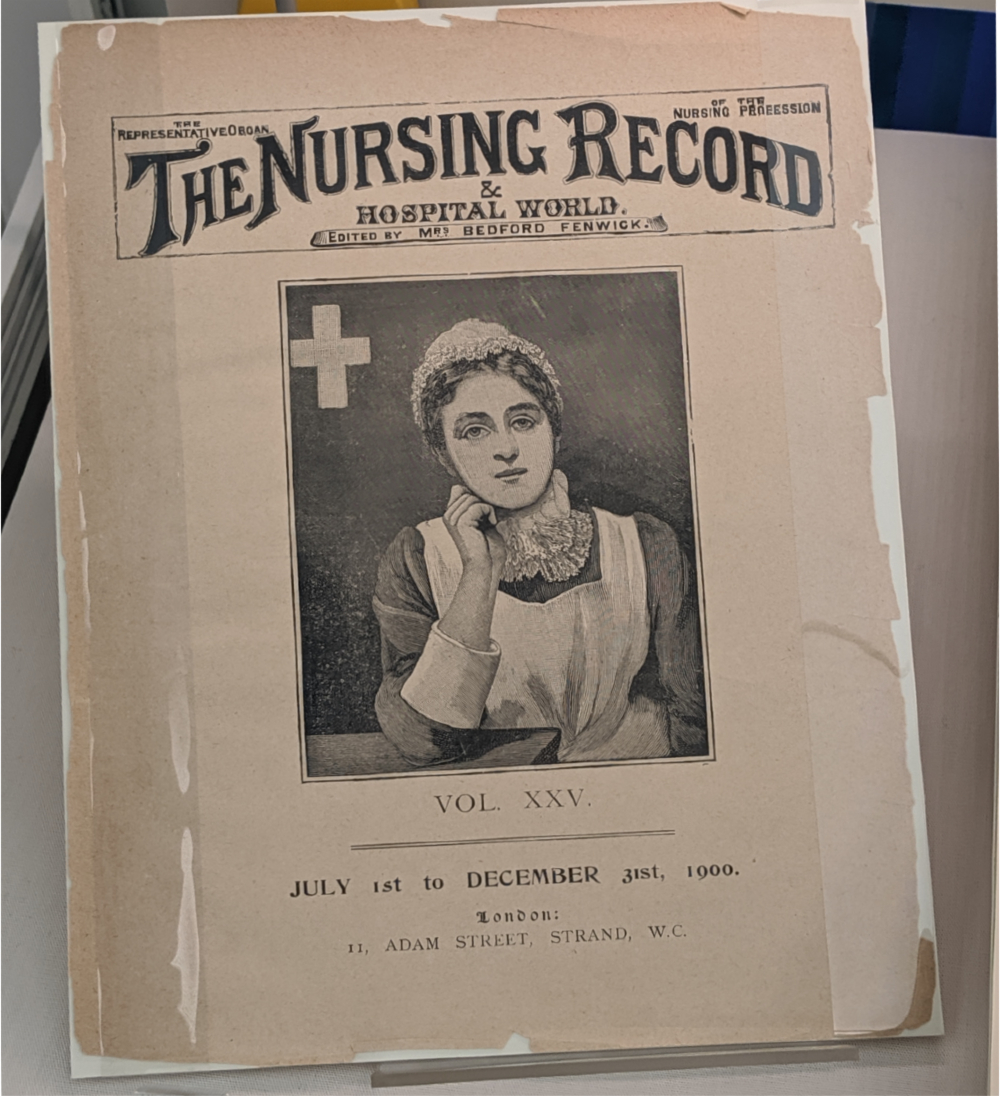 Black and white cover of the December 1900 edition of the Nursing Record showing a nurse in an old fashioned uniform. 