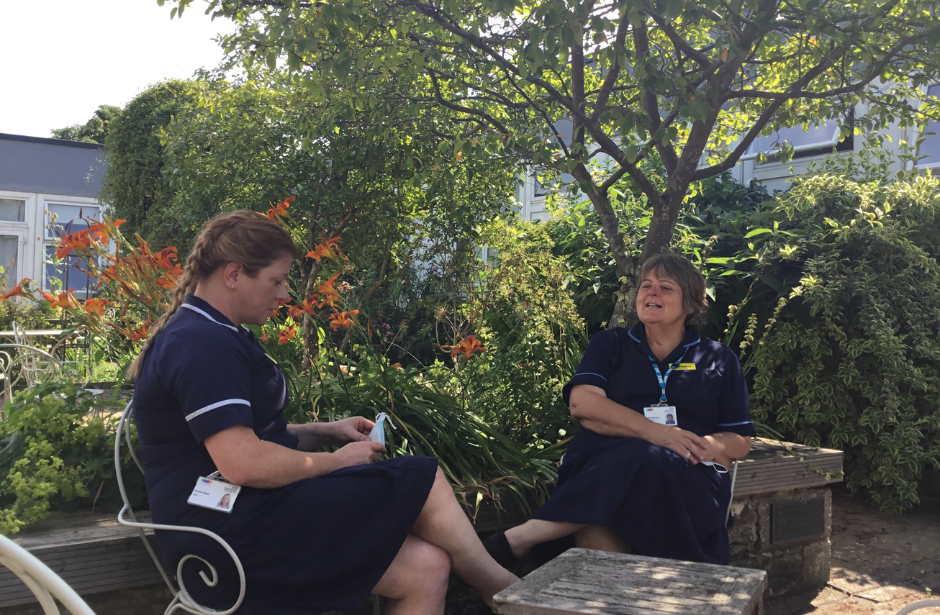 two nurses sitting in garden