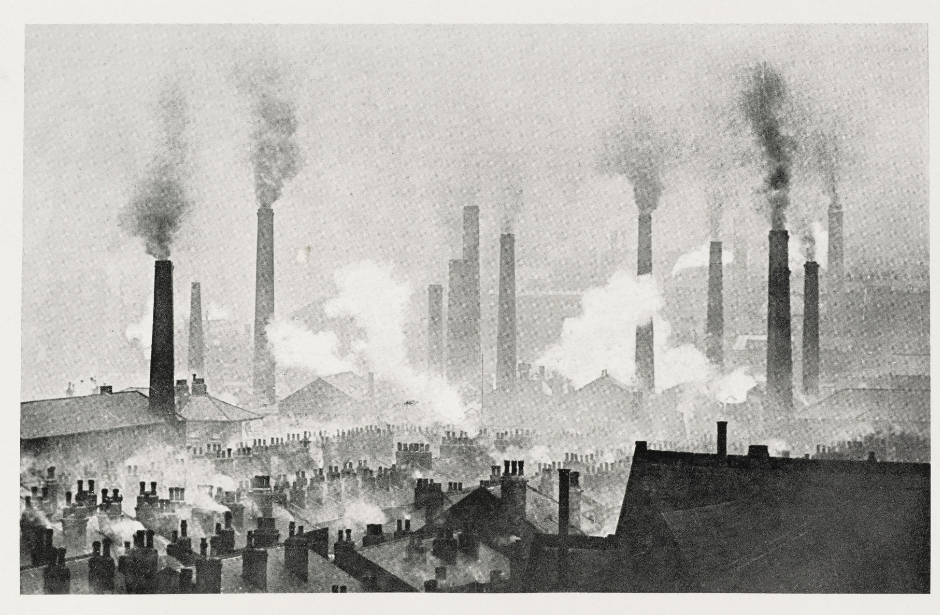 black and white photo of chimneys and smoke