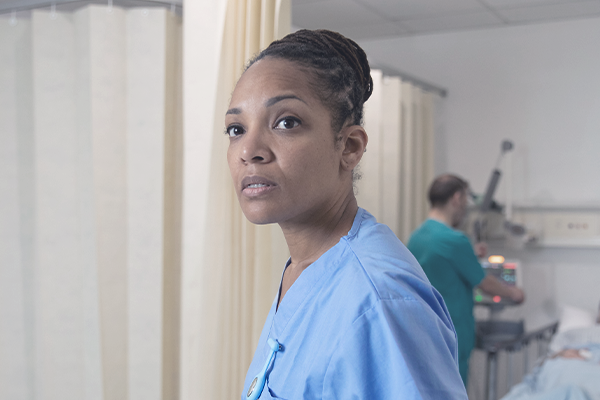 Image of concerned nurse in a hospital setting