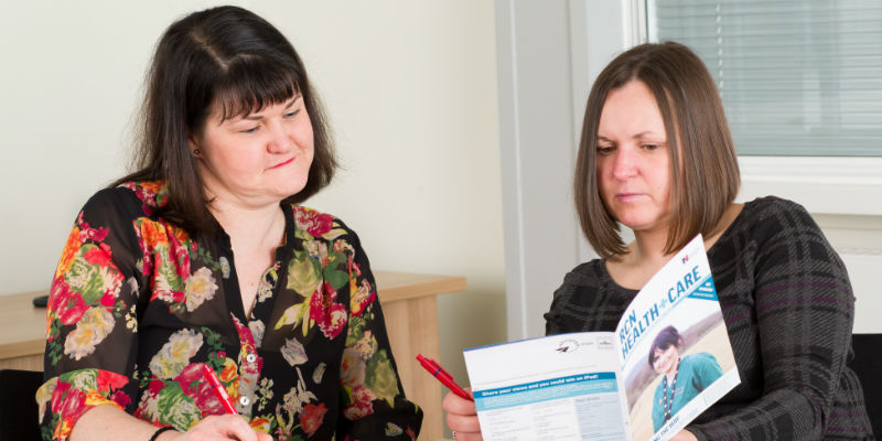 Two RCN members reading an RCN publication