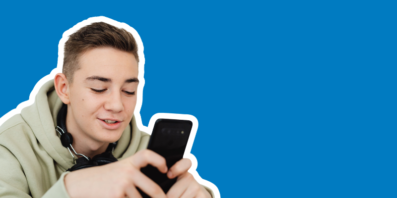 A person holds and looks at a mobile phone
