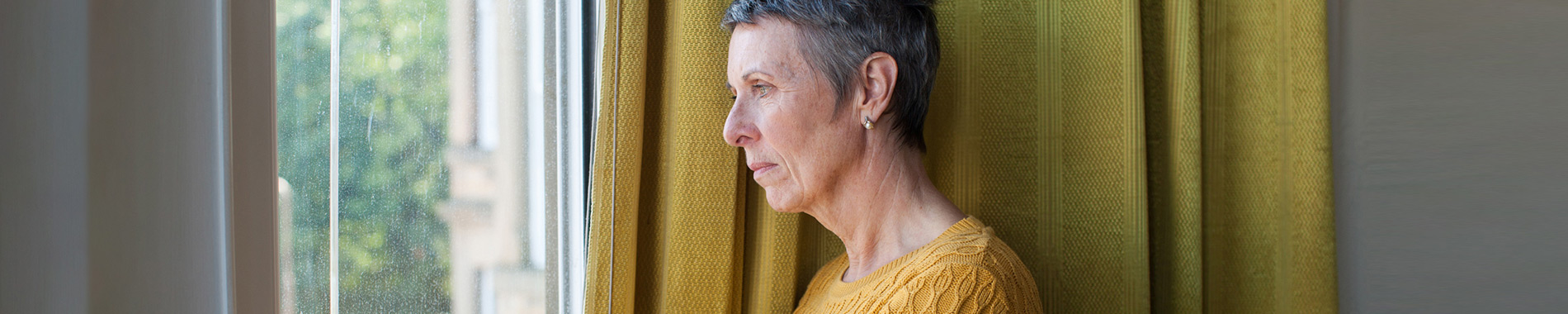 woman staring out of window