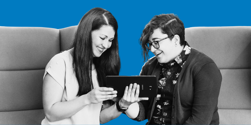 Two people chatting over a tablet