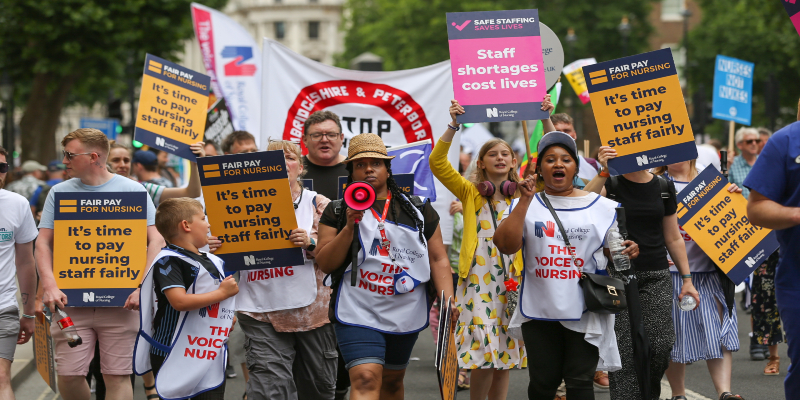 People with RCN fair pay placards on a march in London