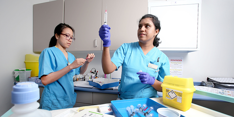 Nurses preparing syringes