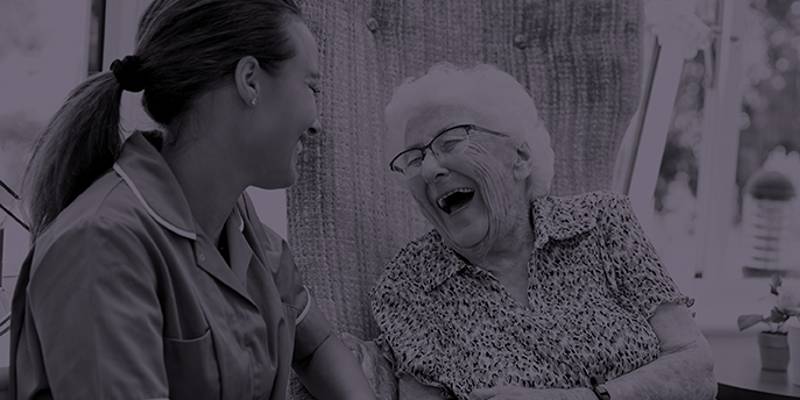 Patient laughing with nursing staff