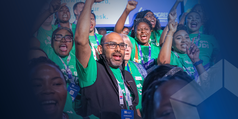 RCN members at Congress holding their arms in the air