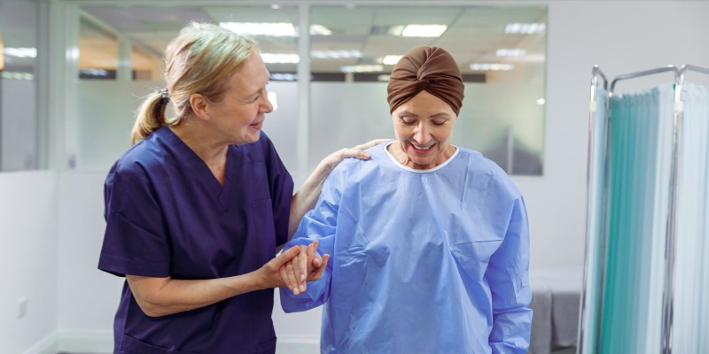 Nurse helping cancer patient walking