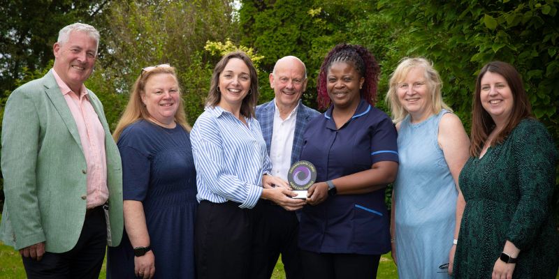 Llinos Medi MP and Mario Kreft MBE, Chair of Care Forum Wales and founder of Wales Care Awards, present the award to Nurse Ezelina Dacruz along with (from left) Elfed Williams MS , Helen Ombier-Williams, Glan Rhos, Kim Ombier Manager of Glan Rhos and Mair Rowlands MS.