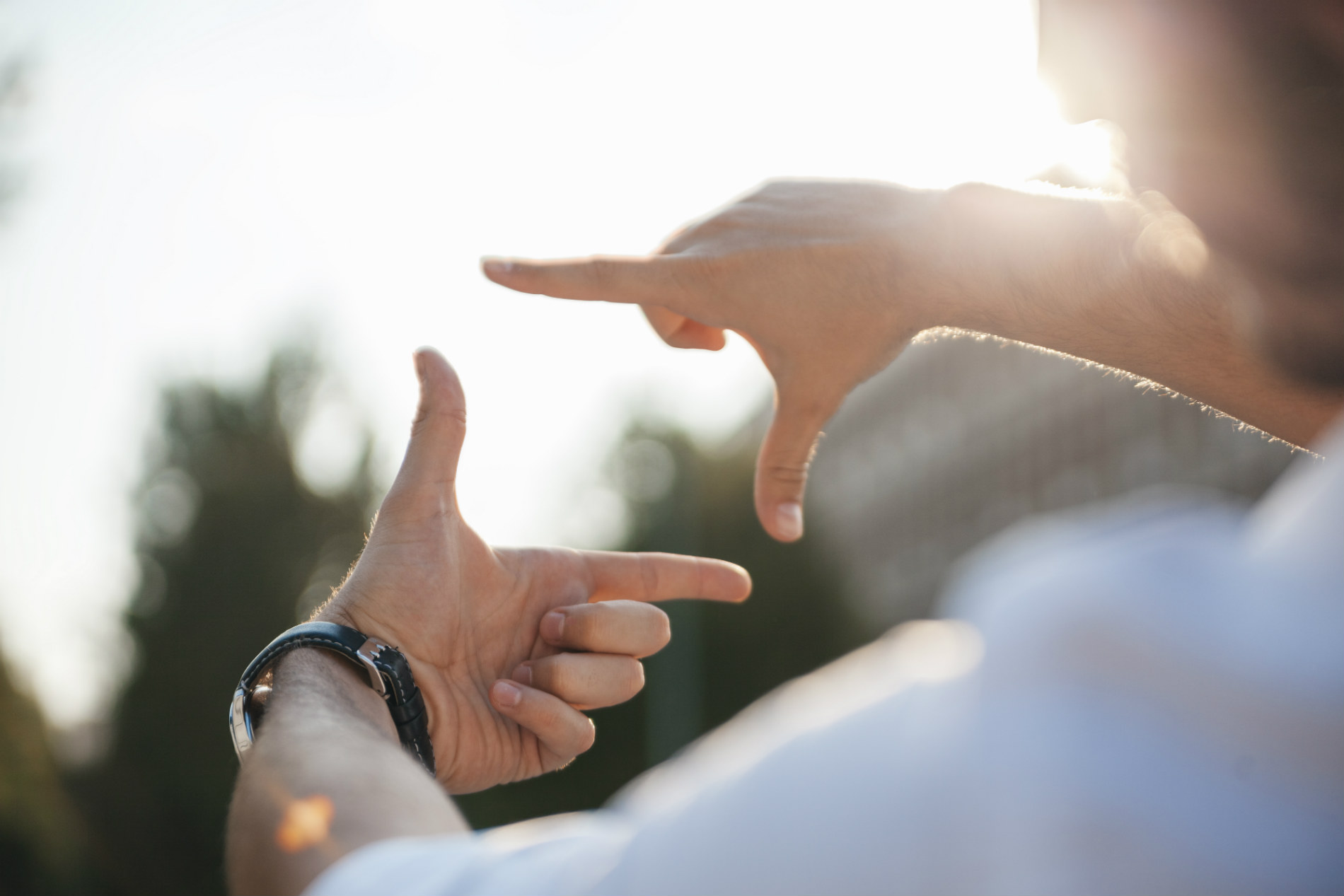 Someone holds their hands up in the shape of a square as if looking through a lens