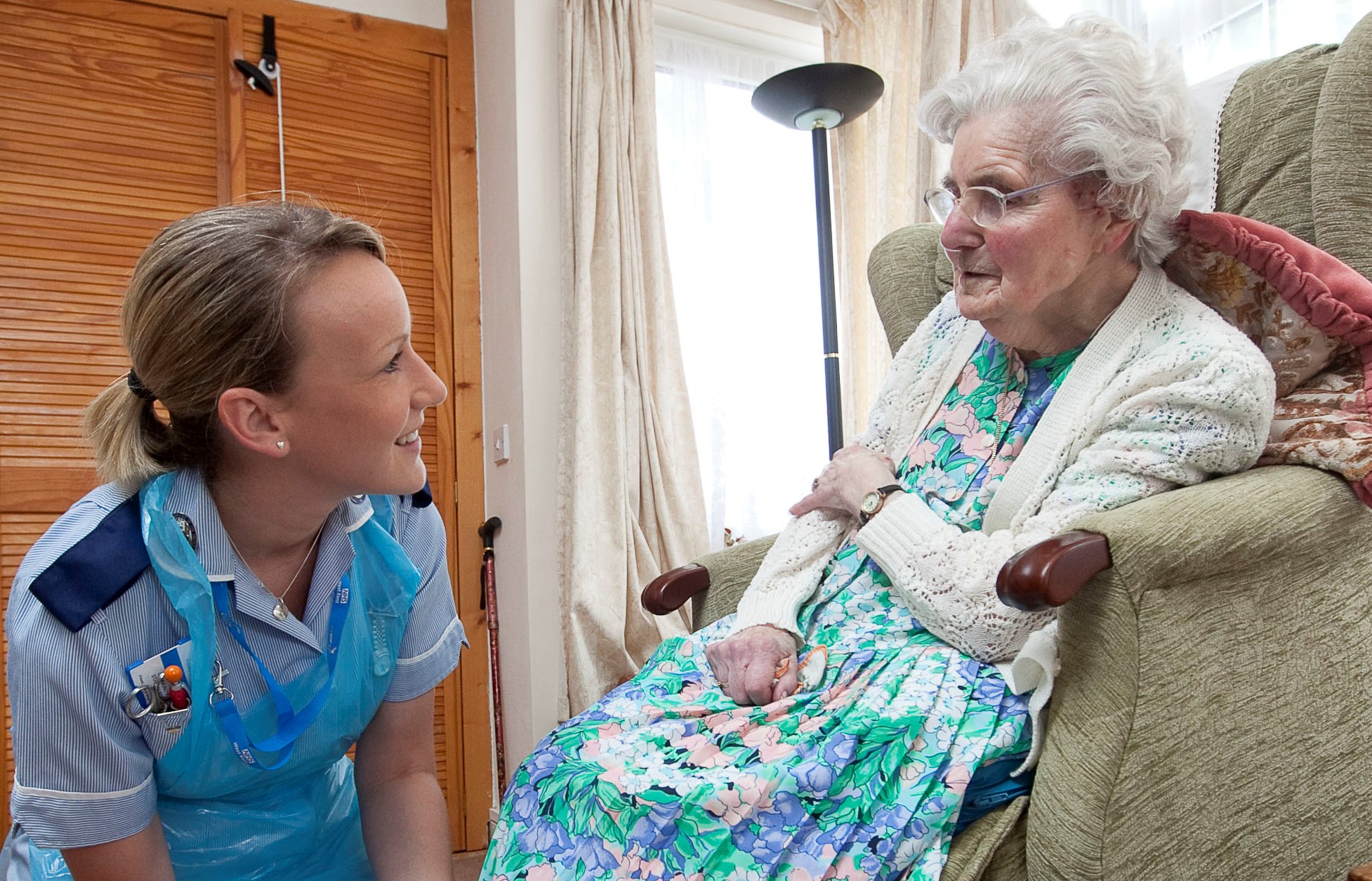 Community nurse tends to a wound on a patient's foot