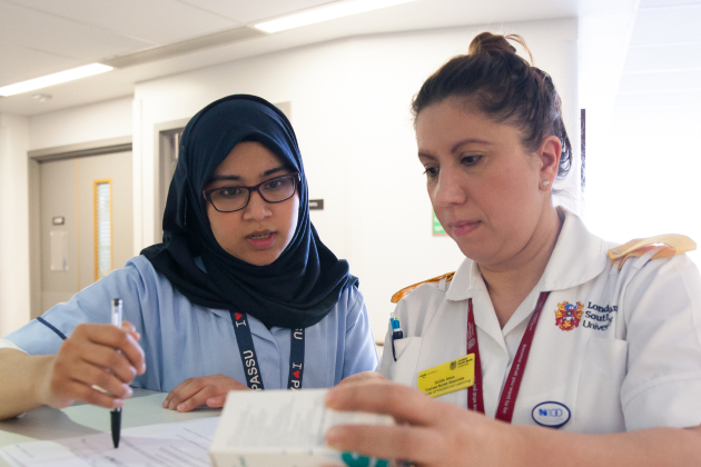 A nurse and a nursing associate in conversation
