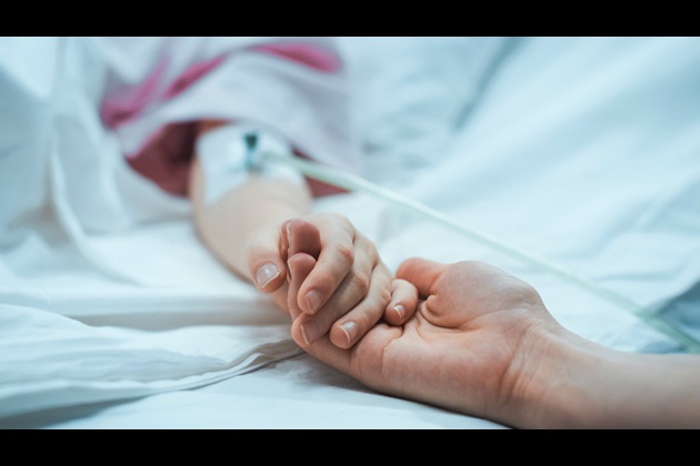 Holding child's hand in hospital
