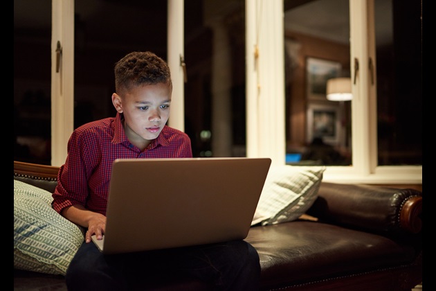 boy looking at laptop