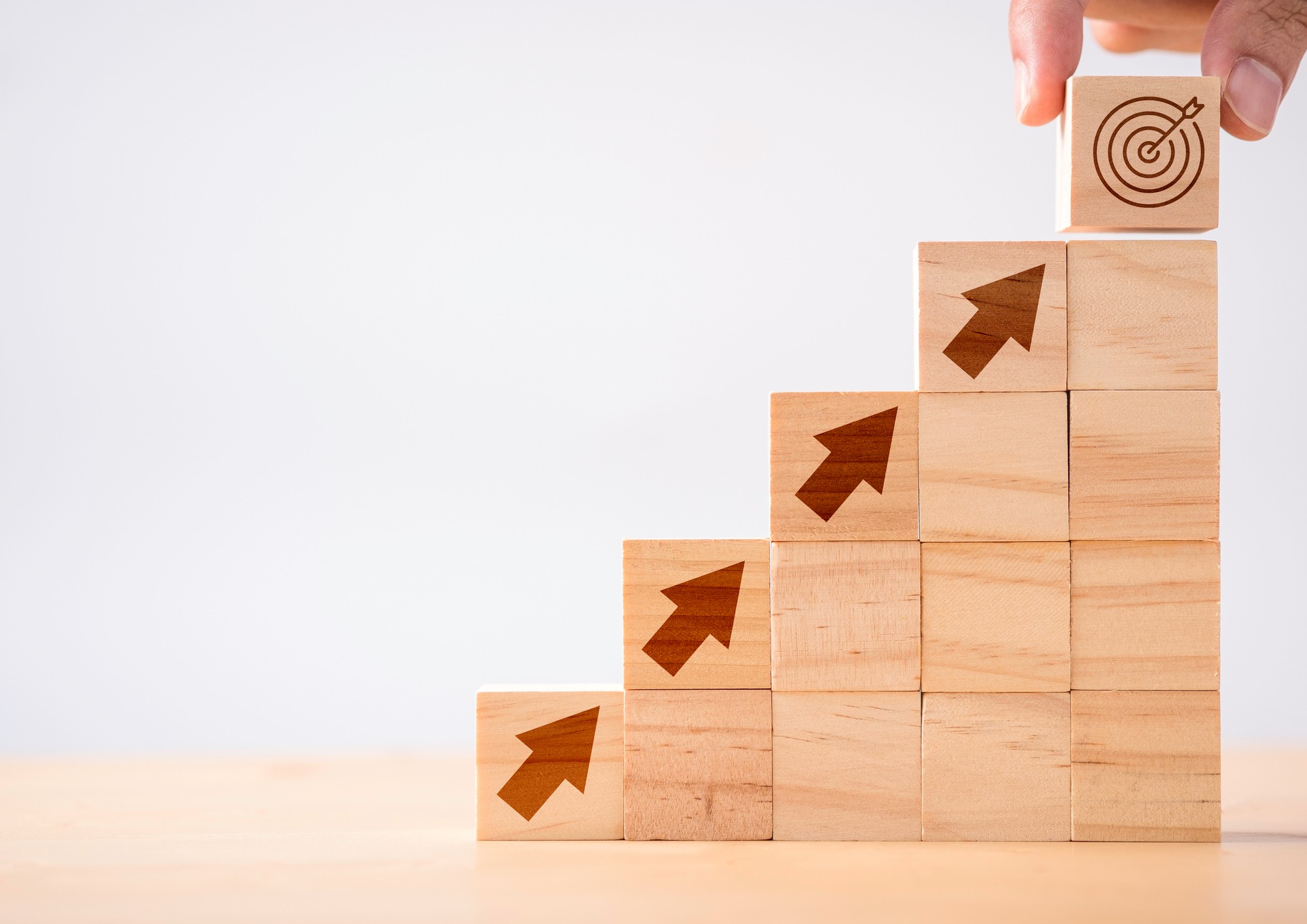 Building blocks increasing in number with arrows pointing upwards