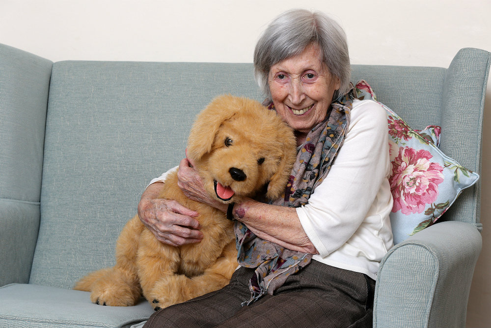 Care Home South resident with robotic dog Biscuit