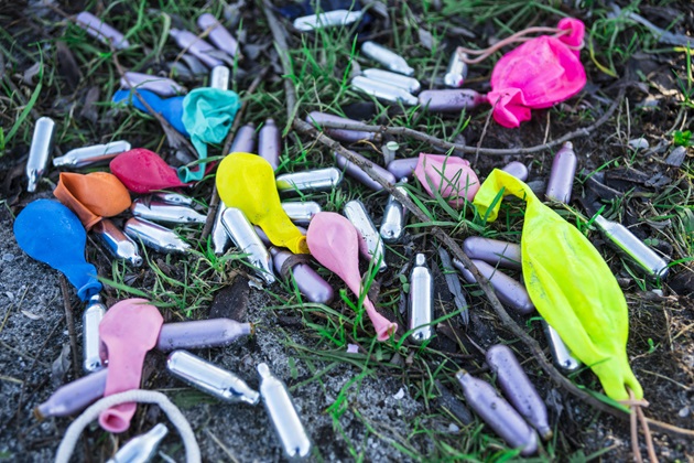 Discarded laughing gas canisters and balloons