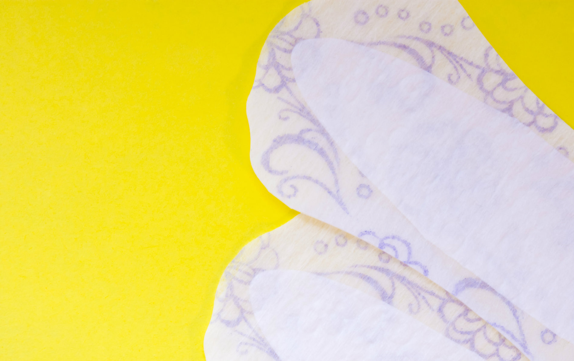 Sanitary products on yellow background