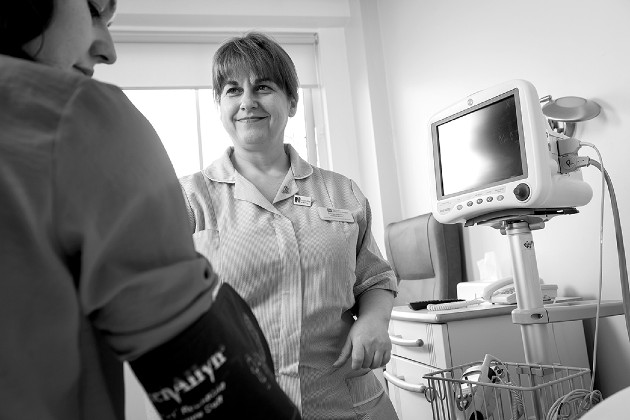 nurse smiling in clinical setting