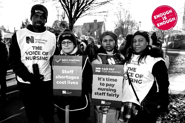 Four members on a picket line in Reading. Image is black and white with red circle campaign logo 'enough is enough'