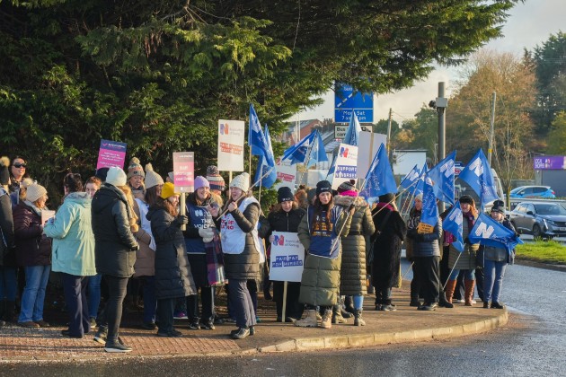 Large group of RCN members on strike outside Ulster Hospital in Northern Ireland with lots of blue RCN flags