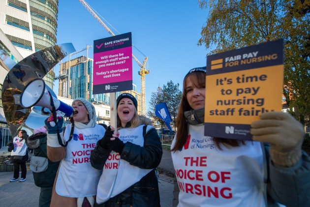 RCN members using a loudspeaker and holding placards at Birmingham picket line