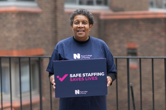 Maive Coley holding a sign with the text safe staffing saves lives on it