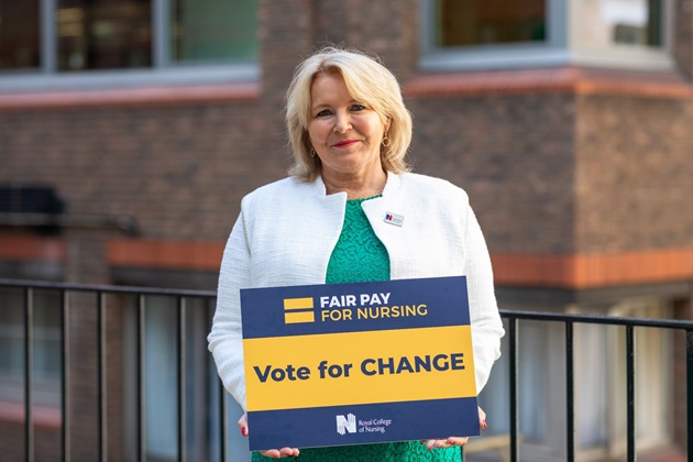 RCN General Secretary & Chief Executive Pat Cullen photographed at RCN HQ London in August 2022, holding a sign that reads 'Vote for change'