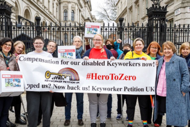 Cass Macdonald, Rachel Hext and Sarah Sutton with supporters handing in their long COVID compensation petition at Downing Street