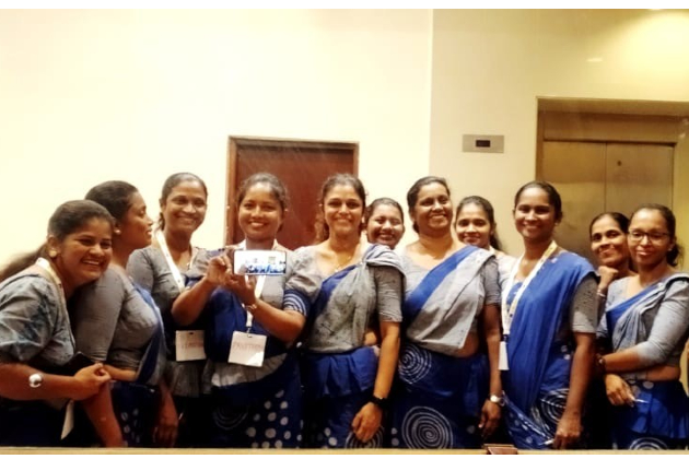 A group of Sri Lanka public heath nurse officers pose for a photo in the mirror