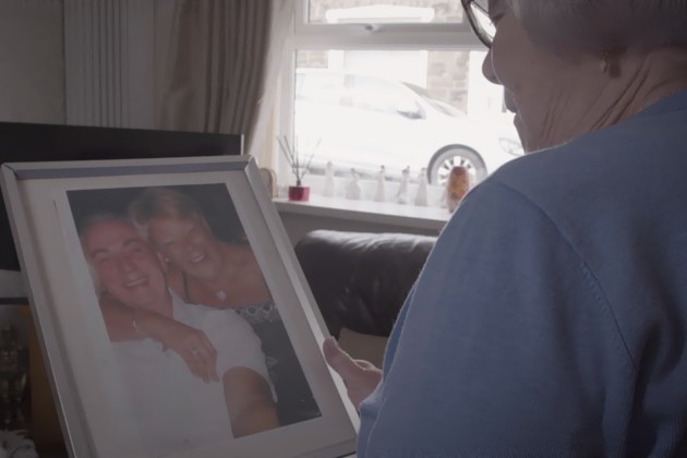 Mrs Roberts looking at a photograph of herself and her husband (Gareth Roberts)